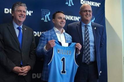 Rhode Island Governor Dan McKee and Director of Athletics Thorr Bjorn flank new University of RI Men  s Basketball coach Archie Miller at the Welcome Center on March 21, 2022.