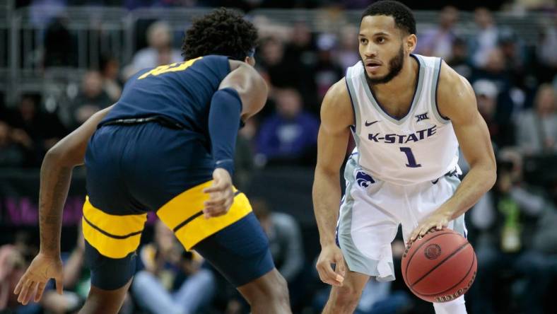 Mar 9, 2022; Kansas City, MO, USA;  Kansas State Wildcats guard Markquis Nowell (1) sets the play against the West Virginia Mountaineers at T-Mobile Center. Mandatory Credit: William Purnell-USA TODAY Sports