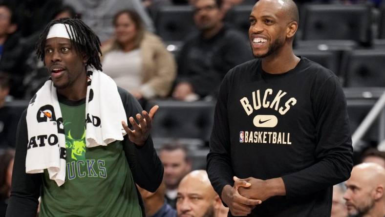 Apr 8, 2022; Detroit, Michigan, USA; Milwaukee Bucks forward Khris Middleton (22) smiles from the bench with guard Jrue Holiday (21) during the fourth quarter at Little Caesars Arena. Mandatory Credit: Raj Mehta-USA TODAY Sports