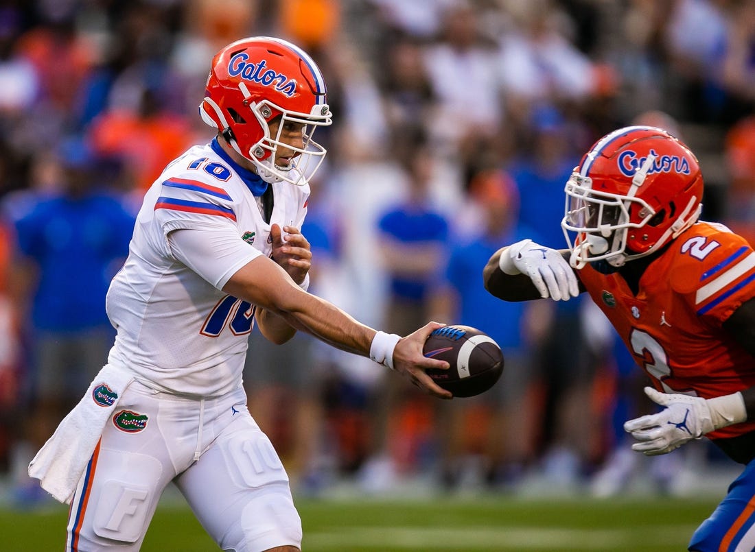 Florida Gators quarterback Jack Miller III (10) hands off to Florida Gators running back Montrell Johnson (2) in the first quarter. The Florida Gators scrimmaged in the first quarter during the annual Orange and Blue spring game at Ben Hill Griffin Stadium in Gainesville, FL, Thursday afternoon, April 14, 2022. [Doug Engle/Ocala Star Banner]2022

Oca Orangeandbluegame