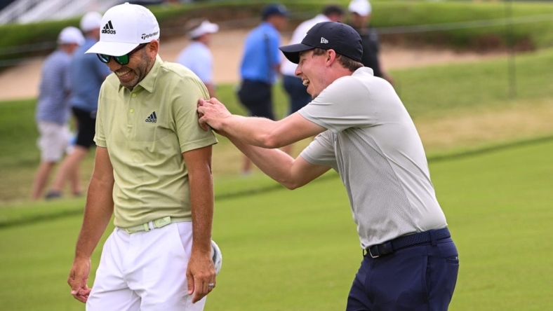 May 20, 2022; Tulsa, OK, USA;  Matthew Fitzpatrick and  Sergio Garcia walk down the first fairway during the second round of the PGA Championship golf tournament at Southern Hills Country Club. Mandatory Credit: Orlando Ramirez-USA TODAY Sports