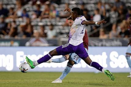 Jul 13, 2022; Commerce City, Colorado, USA; Colorado Rapids defender Keegan Rosenberry (2) kicks the ball as Orlando City midfielder Andres Perea (21) defends in the second half at Dick's Sporting Goods Park. Mandatory Credit: Isaiah J. Downing-USA TODAY Sports