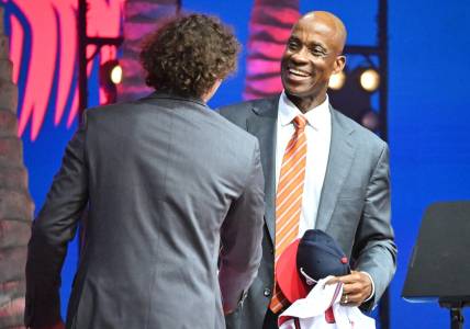 Jul 17, 2022; Los Angeles, CA, USA;  Former Atlanta Braves player Fred McGriff presents JR Ritchie with his jersey after he was selected by the Atlanta Braves as the 35th pick of the MLB draft at XBox Plaza at LA Live. Mandatory Credit: Jayne Kamin-Oncea-USA TODAY Sports