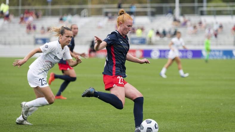 CARY, NC - APRIL 10: Meredith Speck #25 of the NC Courage gives chase as Tori Huster #23 of the Washington Spirit passes the ball during a game between Washington Spirit and North Carolina Courage at Sahlen's Stadium at WakeMed Soccer Park on April 10, 2021 in Cary, North Carolina.