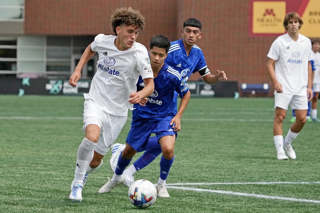 Aug 10, 2022; Blaine, MN, USA; MLS Next East player Favian Loyola (16) of Orlando City dribbles the ball against MLS Next West during the second half of the 2022 MLS NEXT All-Star Game at National Sports Center Indoor Sports Hall. Mandatory Credit: Kirby Lee-USA TODAY Sports