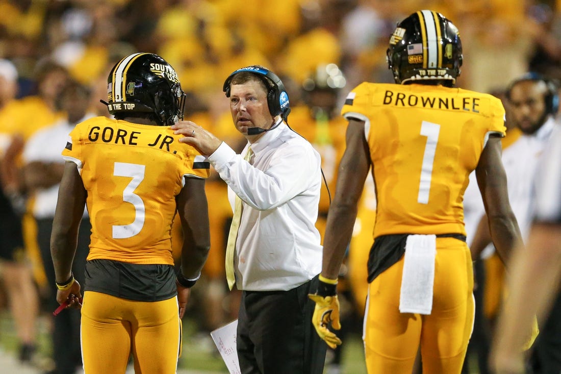 Sep 3, 2022; Hattiesburg, Mississippi, USA; Southern Miss Golden Eagles head coach Will Hall talks to running back Frank Gore Jr. (3) in the second half at M.M. Roberts Stadium. Liberty won in overtime, 29-27. Mandatory Credit: Chuck Cook-USA TODAY Sports