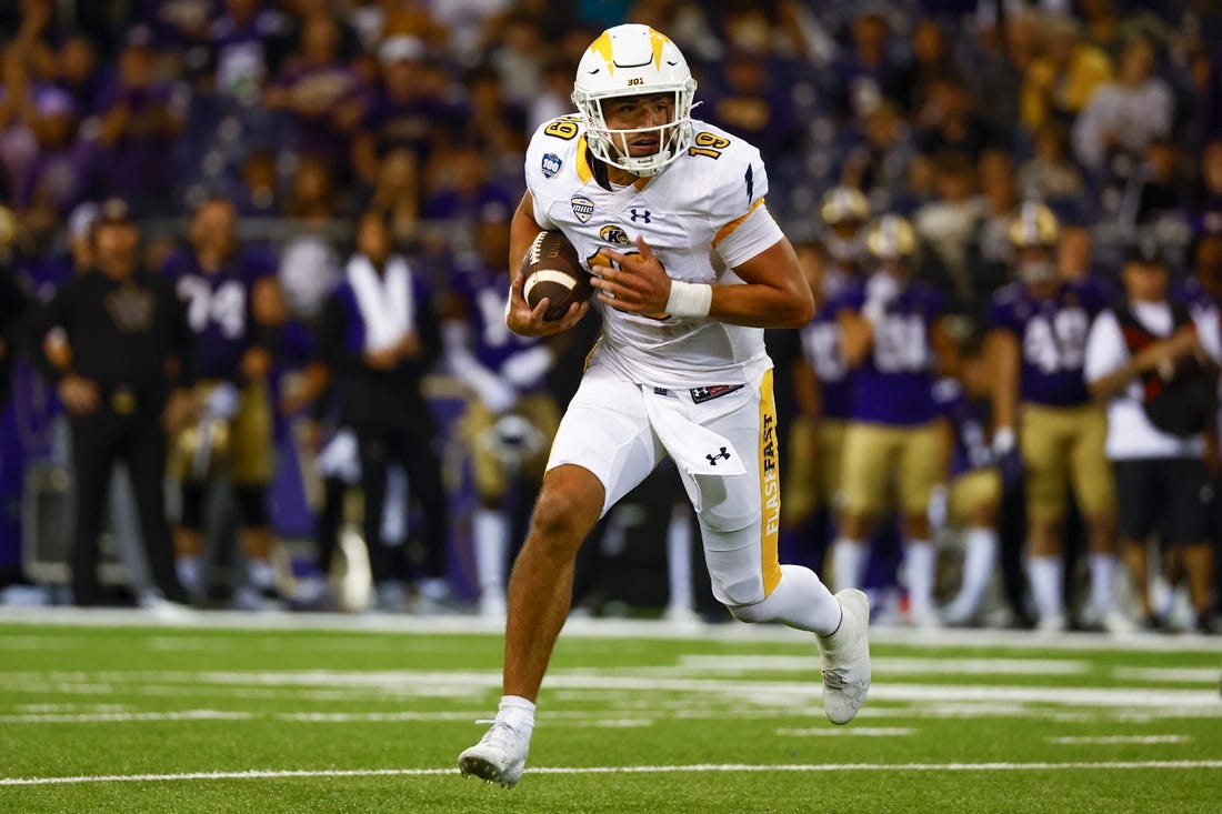 Sep 3, 2022; Seattle, Washington, USA; Kent State Golden Flashes quarterback Collin Schlee (19) rushes against the Washington Huskies during the second quarter at Alaska Airlines Field at Husky Stadium. Mandatory Credit: Joe Nicholson-USA TODAY Sports