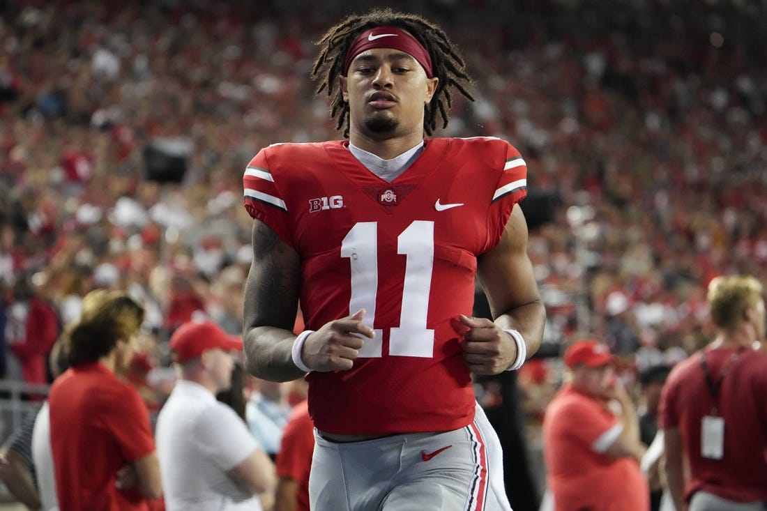 Sep 3, 2022; Columbus, Ohio, USA;  Ohio State Buckeyes wide receiver Jaxon Smith-Njigba (11) runs on the sideline after taking a hard hit during the NCAA football game against the Notre Dame Fighting Irish at Ohio Stadium. Mandatory Credit: Adam Cairns-USA TODAY Sports