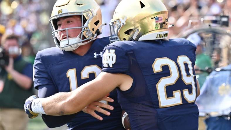 Sep 10, 2022; South Bend, Indiana, USA; Notre Dame Fighting Irish quarterback Tyler Buchner (12) celebrates with wide receiver Matt Salerno (29) after running for a two point conversation in the fourth quarter against the Marshall Thundering Herd at Notre Dame Stadium. Mandatory Credit: Matt Cashore-USA TODAY Sports