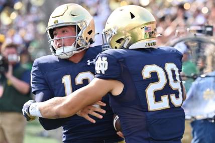 Sep 10, 2022; South Bend, Indiana, USA; Notre Dame Fighting Irish quarterback Tyler Buchner (12) celebrates with wide receiver Matt Salerno (29) after running for a two point conversation in the fourth quarter against the Marshall Thundering Herd at Notre Dame Stadium. Mandatory Credit: Matt Cashore-USA TODAY Sports