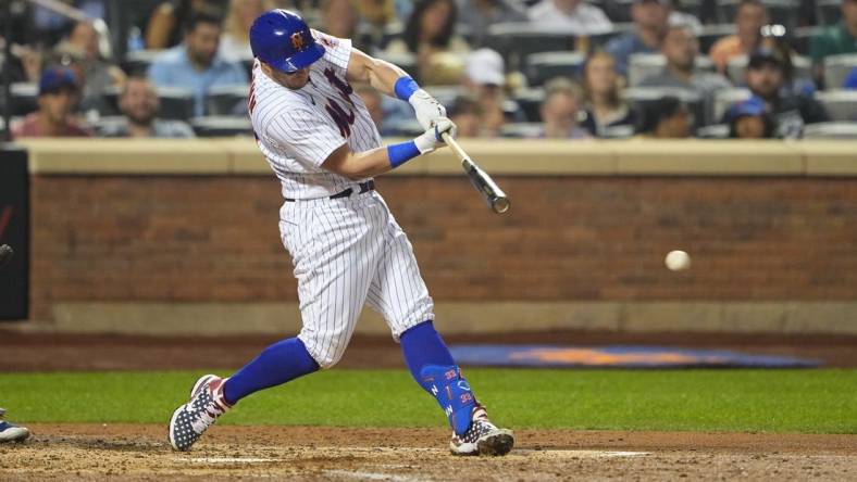 Sep 12, 2022; New York City, New York, USA; New York Mets catcher James McCann (33) hits an RBI single against the Chicago Cubs during the fourth inning at Citi Field. Mandatory Credit: Gregory Fisher-USA TODAY Sports