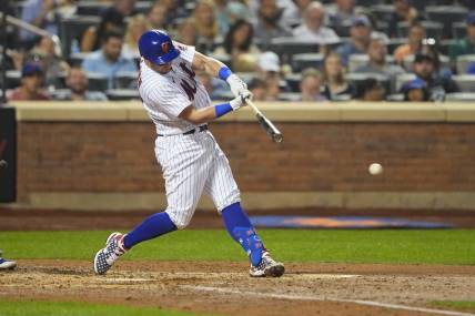 Sep 12, 2022; New York City, New York, USA; New York Mets catcher James McCann (33) hits an RBI single against the Chicago Cubs during the fourth inning at Citi Field. Mandatory Credit: Gregory Fisher-USA TODAY Sports