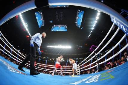 Sep 17, 2022; Las Vegas, Nevada, USA; Canelo Alvarez (red trunks) and Gennadiy Golovkin (white trunks) box during a middleweight championship bout at T-Mobile Arena. Mandatory Credit: Joe Camporeale-USA TODAY Sports