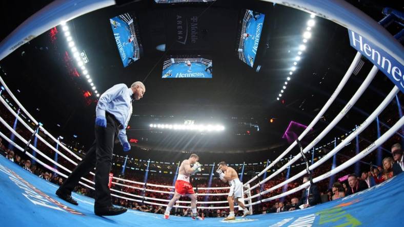 Sep 17, 2022; Las Vegas, Nevada, USA; Canelo Alvarez (red trunks) and Gennadiy Golovkin (white trunks) box during a middleweight championship bout at T-Mobile Arena. Mandatory Credit: Joe Camporeale-USA TODAY Sports