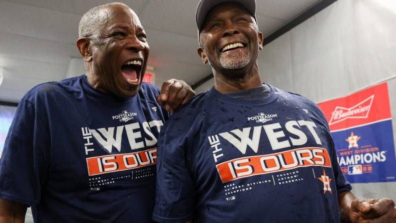 Sep 19, 2022; St. Petersburg, Florida, USA;  Houston Astros manager Dusty Baker Jr. (12) and third base coach Gary Pettis (8) celebrate winning the American League West at Tropicana Field. Mandatory Credit: Nathan Ray Seebeck-USA TODAY Sports