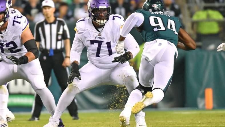 Sep 19, 2022; Philadelphia, Pennsylvania, USA;  Minnesota Vikings offensive tackle Christian Darrisaw (71) blocks Philadelphia Eagles defensive end Josh Sweat (94) at Lincoln Financial Field. Mandatory Credit: Eric Hartline-USA TODAY Sports