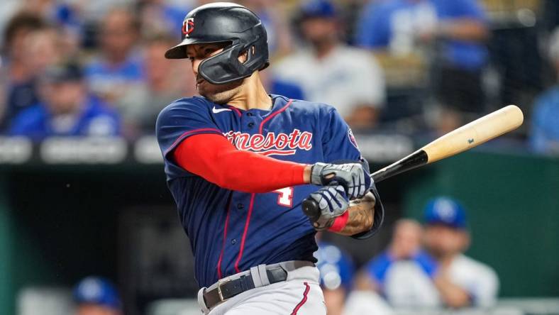 Sep 20, 2022; Kansas City, Missouri, USA; Minnesota Twins shortstop Carlos Correa (4) hits a two-run single against the Kansas City Royals during the second inning at Kauffman Stadium. Mandatory Credit: Jay Biggerstaff-USA TODAY Sports