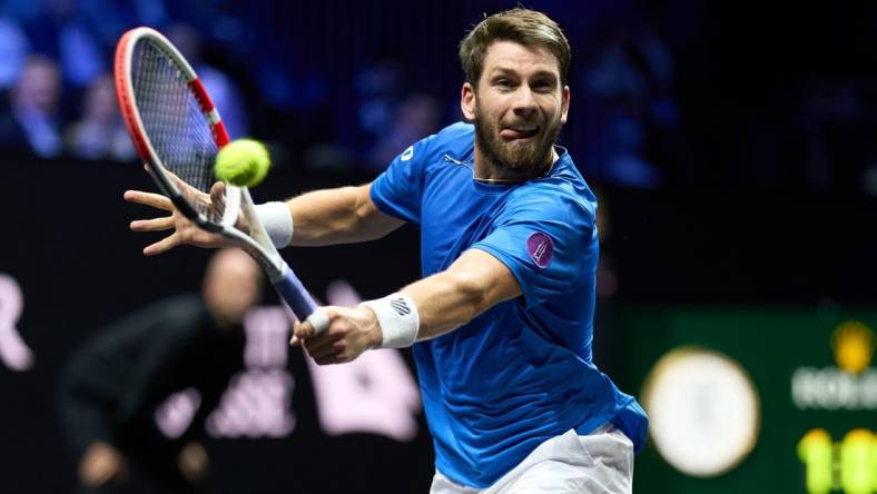 Sep 24, 2022; London, United Kingdom;
Cameron Norrie (GBR) plays a shot against Taylor Fritz (USA) in a Laver Cup singles match.  Mandatory Credit: Peter van den Berg-USA TODAY Sports