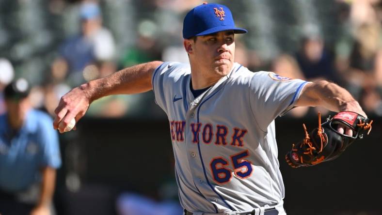 Sep 24, 2022; Oakland, California, USA; New York Mets relief pitcher Trevor May (65) throws a pitch against the Oakland Athletics during the eighth inning at RingCentral Coliseum. Mandatory Credit: Robert Edwards-USA TODAY Sports