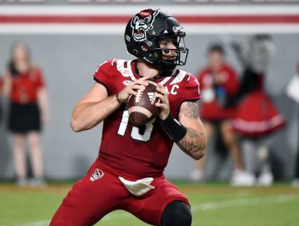 Sep 24, 2022; Raleigh, North Carolina, USA; North Carolina State Wolfpack quarterback Devin Leary (13) looks to throw during the first half against the Connecticut Huskies at Carter-Finley Stadium. Mandatory Credit: Rob Kinnan-USA TODAY Sports