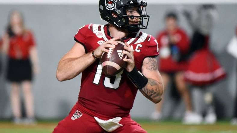 Sep 24, 2022; Raleigh, North Carolina, USA; North Carolina State Wolfpack quarterback Devin Leary (13) looks to throw during the first half against the Connecticut Huskies at Carter-Finley Stadium. Mandatory Credit: Rob Kinnan-USA TODAY Sports