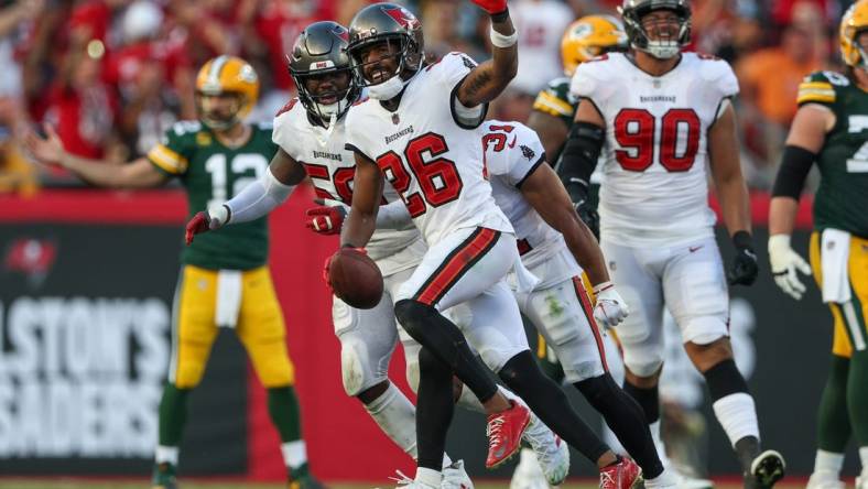 Sep 25, 2022; Tampa, Florida, USA;  Tampa Bay Buccaneers safety Logan Ryan (26) reacts after intercepting the ball against the Green Bay Packers in the third quarter at Raymond James Stadium. Mandatory Credit: Nathan Ray Seebeck-USA TODAY Sports