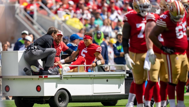 September 18, 2022; Santa Clara, California, USA; San Francisco 49ers quarterback Trey Lance (5) is carted off the field by medical staff after an injury during the first quarter against the Seattle Seahawks at Levi's Stadium. Mandatory Credit: Kyle Terada-USA TODAY Sports