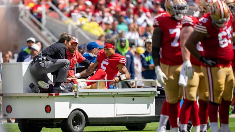 September 18, 2022; Santa Clara, California, USA; San Francisco 49ers quarterback Trey Lance (5) is carted off the field by medical staff after an injury during the first quarter against the Seattle Seahawks at Levi's Stadium. Mandatory Credit: Kyle Terada-USA TODAY Sports
