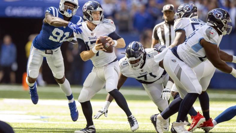 Oct 2, 2022; Indianapolis, Indiana, USA;  Tennessee Titans quarterback Ryan Tannehill (17) narrowly misses being sacked by Indianapolis Colts defensive end Yannick Ngakoue (91) during the first quarter at Lucas Oil Stadium. Mandatory Credit: Marc Lebryk-USA TODAY Sports