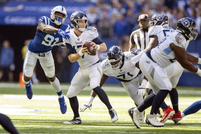 Oct 2, 2022; Indianapolis, Indiana, USA;  Tennessee Titans quarterback Ryan Tannehill (17) narrowly misses being sacked by Indianapolis Colts defensive end Yannick Ngakoue (91) during the first quarter at Lucas Oil Stadium. Mandatory Credit: Marc Lebryk-USA TODAY Sports