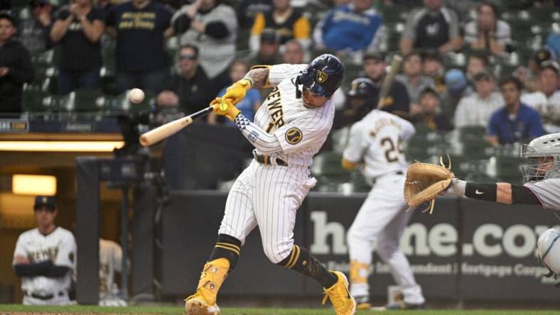 Oct 2, 2022; Milwaukee, Wisconsin, USA; Milwaukee Brewers second baseman Kolten Wong (16) hits an RBI single to tie the game in the ninth inning against the Milwaukee Brewers at American Family Field. Mandatory Credit: Michael McLoone-USA TODAY Sports