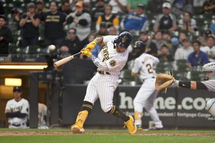 Oct 2, 2022; Milwaukee, Wisconsin, USA; Milwaukee Brewers second baseman Kolten Wong (16) hits an RBI single to tie the game in the ninth inning against the Milwaukee Brewers at American Family Field. Mandatory Credit: Michael McLoone-USA TODAY Sports