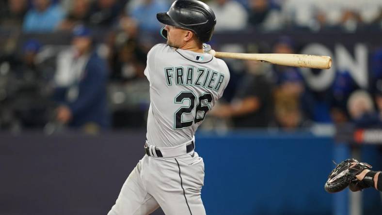 Oct 7, 2022; Toronto, Ontario, CAN; Seattle Mariners second baseman Adam Frazier (26) hits a single in the second inning against the Toronto Blue Jays during game one of the Wild Card series for the 2022 MLB Playoffs at Rogers Centre. Mandatory Credit: Nick Turchiaro-USA TODAY Sports