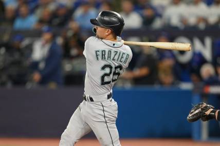 Oct 7, 2022; Toronto, Ontario, CAN; Seattle Mariners second baseman Adam Frazier (26) hits a single in the second inning against the Toronto Blue Jays during game one of the Wild Card series for the 2022 MLB Playoffs at Rogers Centre. Mandatory Credit: Nick Turchiaro-USA TODAY Sports