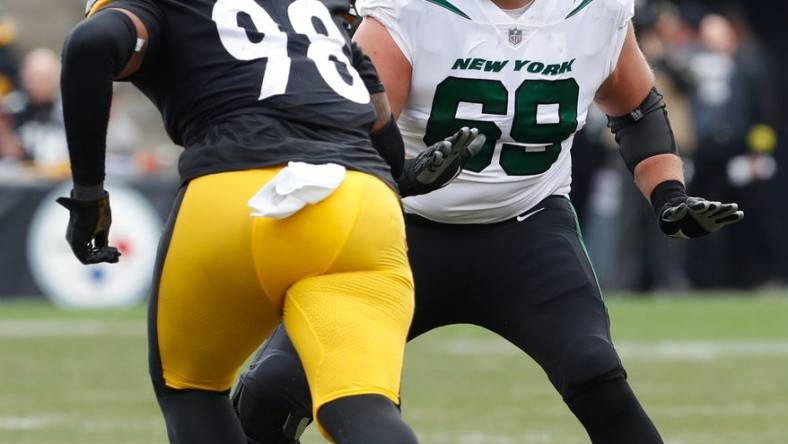 Oct 2, 2022; Pittsburgh, Pennsylvania, USA;  New York Jets offensive tackle Conor McDermott (69) blocks at he line of scrimmage against Pittsburgh Steelers defensive end DeMarvin Leal (98) during the second quarter at Acrisure Stadium. Mandatory Credit: Charles LeClaire-USA TODAY Sports