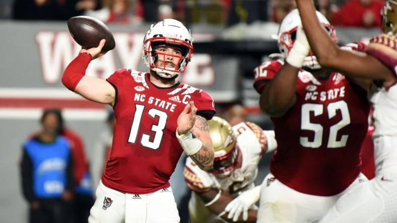 Oct 8, 2022; Raleigh, North Carolina, USA; North Carolina State Wolfpack quarterback Devin Leary (13) throws a pass during the first half against the Florida State Seminoles at Carter-Finley Stadium. Mandatory Credit: Rob Kinnan-USA TODAY Sports