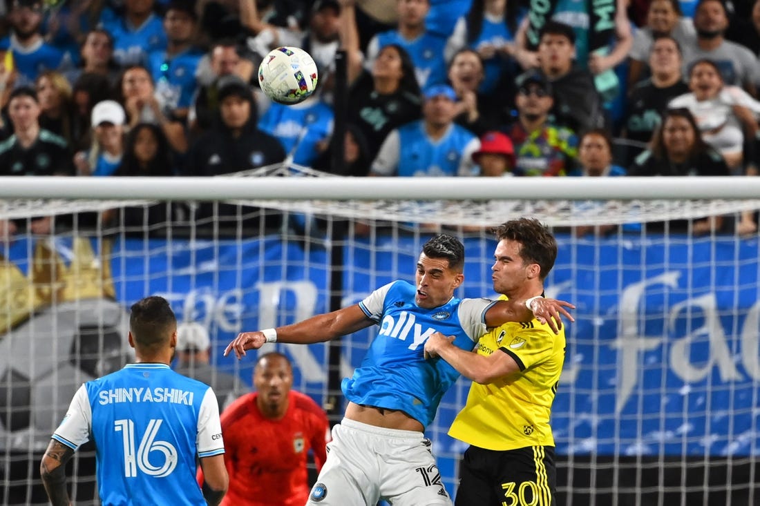 Oct 5, 2022; Charlotte, North Carolina, USA; Charlotte FC forward Daniel Rios (12) and Columbus Crew defender Will Sands (30) fight for the header in the second half at Bank of America Stadium. Mandatory Credit: Bob Donnan-USA TODAY Sports