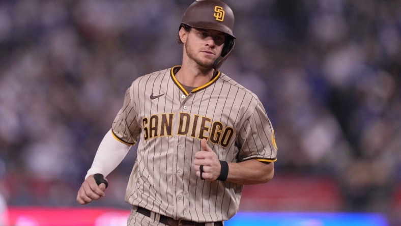 Oct 11, 2022; Los Angeles, California, USA; San Diego Padres right fielder Wil Myers (5) rounds the bases after hitting a home run during the fifth inning of game one of the NLDS for the 2022 MLB Playoffs against the Los Angeles Dodgers at Dodger Stadium. Mandatory Credit: Kirby Lee-USA TODAY Sports