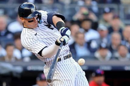 Oct 18, 2022; Bronx, New York, USA; New York Yankees right fielder Aaron Judge (99) hits a home run against the Cleveland Guardians during the second inning in game five of the ALDS for the 2022 MLB Playoffs at Yankee Stadium. Mandatory Credit: Brad Penner-USA TODAY Sports