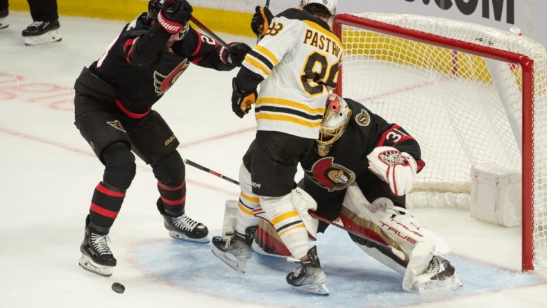 Oct 18, 2022; Ottawa, Ontario, CAN; Ottawa Senators goalie Anton Forsberg (31) makes a save in front of Boston Bruins right wing David Pastrnak (88) in the third period at the Canadian Tire Centre. Mandatory Credit: Marc DesRosiers-USA TODAY Sports