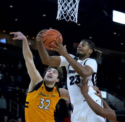 Providence shooter Bryce Hopkins drives in for a lay up over AIC defender Buka Peikrishvili.