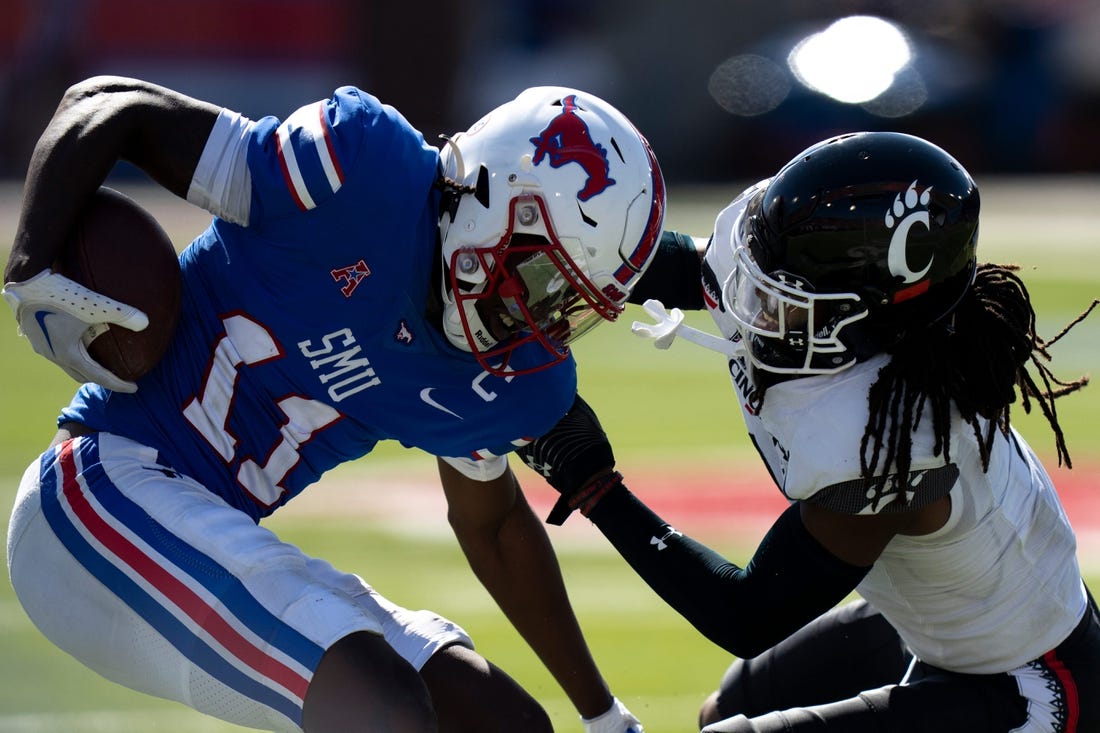 Cincinnati Bearcats cornerback Arquon Bush (9) tackles Southern Methodist Mustangs wide receiver Rashee Rice (11) in the fourth quarter of the American Athletic Conference game at Gerald J. Ford Stadium in Dallas on Saturday, Oct. 22, 2022. Cincinnati Bearcats defeated Southern Methodist Mustangs 29-27.

Cincinnati Bearcats At Southern Methodist Mustangs 730