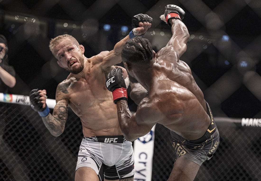 Oct 22, 2022; Abu Dhabi, UAE; Aljamain Sterling (red gloves) and T.J. Dillashaw (blue gloves) during UFC 280 at Etihad Arena. Mandatory Credit: Craig Kidwell-USA TODAY Sports