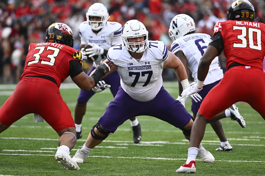 Oct 22, 2022; College Park, Maryland, USA; Northwestern Wildcats offensive lineman Peter Skoronski (77) prepares to block against the Maryland Terrapins at SECU Stadium. Mandatory Credit: Brad Mills-USA TODAY Sports