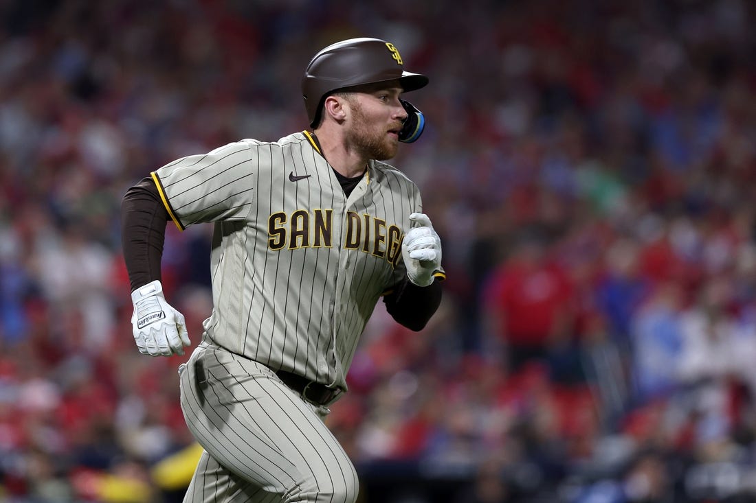Oct 22, 2022; Philadelphia, Pennsylvania, USA; San Diego Padres first baseman Brandon Drury (17) watches his two-RBI double in the first inning during game four of the NLCS against the Philadelphia Phillies for the 2022 MLB Playoffs at Citizens Bank Park. Mandatory Credit: Bill Streicher-USA TODAY Sports
