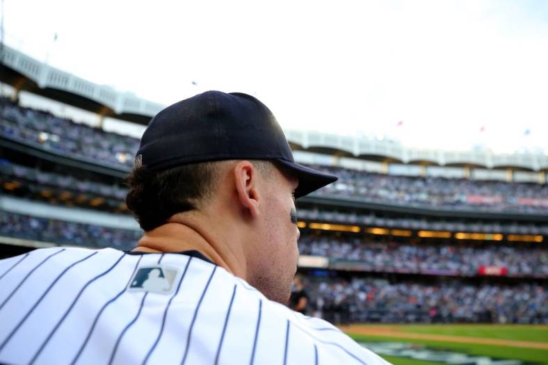 Oct 22, 2022; Bronx, New York, USA; New York Yankees right fielder Aaron Judge (99) looks out of the dugout before taking the field for the start of game three of the ALCS against the Houston Astros during the 2022 MLB Playoffs at Yankee Stadium. Mandatory Credit: Brad Penner-USA TODAY Sports