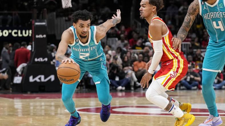 Oct 23, 2022; Atlanta, Georgia, USA; Charlotte Hornets guard James Bouknight (2) dribbles past Atlanta Hawks guard Trae Young (11) during the second half at State Farm Arena. Mandatory Credit: Dale Zanine-USA TODAY Sports