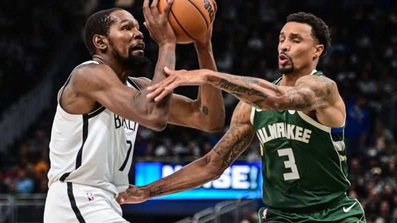 Oct 26, 2022; Milwaukee, Wisconsin, USA; Brooklyn Nets forward Kevin Durant (7) takes a shot against Milwaukee Bucks guard George Hill (3) in the third quarter at Fiserv Forum. Mandatory Credit: Benny Sieu-USA TODAY Sports