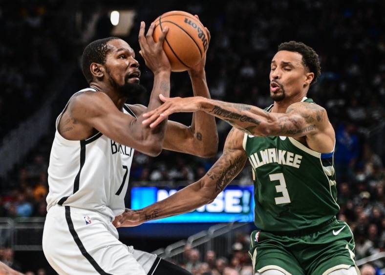 Oct 26, 2022; Milwaukee, Wisconsin, USA; Brooklyn Nets forward Kevin Durant (7) takes a shot against Milwaukee Bucks guard George Hill (3) in the third quarter at Fiserv Forum. Mandatory Credit: Benny Sieu-USA TODAY Sports