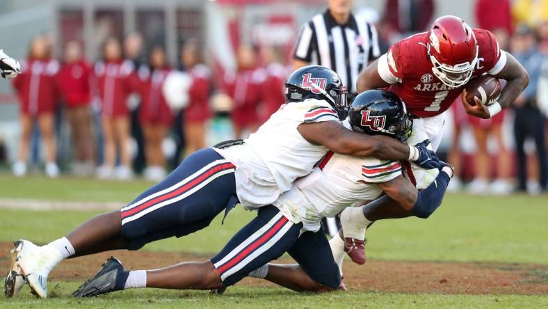 Nov 5, 2022; Fayetteville, Arkansas, USA; Liberty Flames defensive tackle Dre Butler (5) and defensive end Durrell Johnson (11) tackle Arkansas Razorbacks quarterback KJ Jefferson (1) in the second half at Donald W. Reynolds Razorback Stadium. Liberty won 21-19. Mandatory Credit: Nelson Chenault-USA TODAY Sports